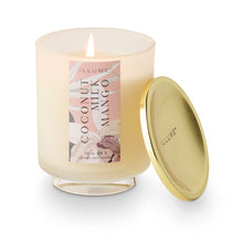 Load image into Gallery viewer, Coconut Milk Mango Candle, frosted glass jar with lit white wax candle on clear pedestal base and dusty rose tropical design label, round gold-tone brass lid beside candle, displayed against white background. 