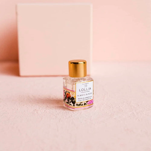 A small bottle of perfume with a white label with 