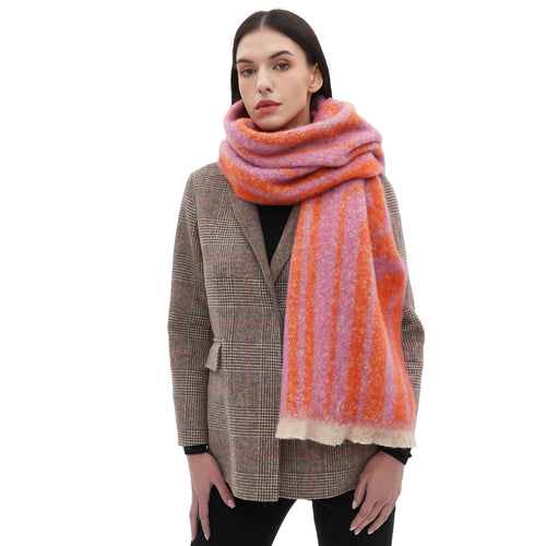A person wearing a gray coat and a pink and orange striped scarf, wrapped around neck. Standing against a white background.