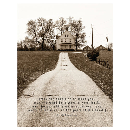 Notecard with a sepia toned picture of a long driveway up to a vintage white farmhouse. Leafless trees and power lines are in the background. Text reads 