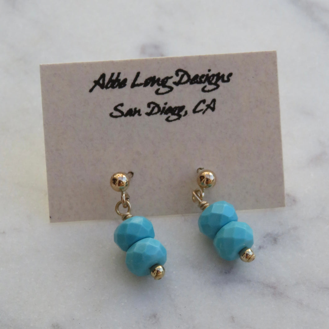 Turquoise beaded earrings on a card with 