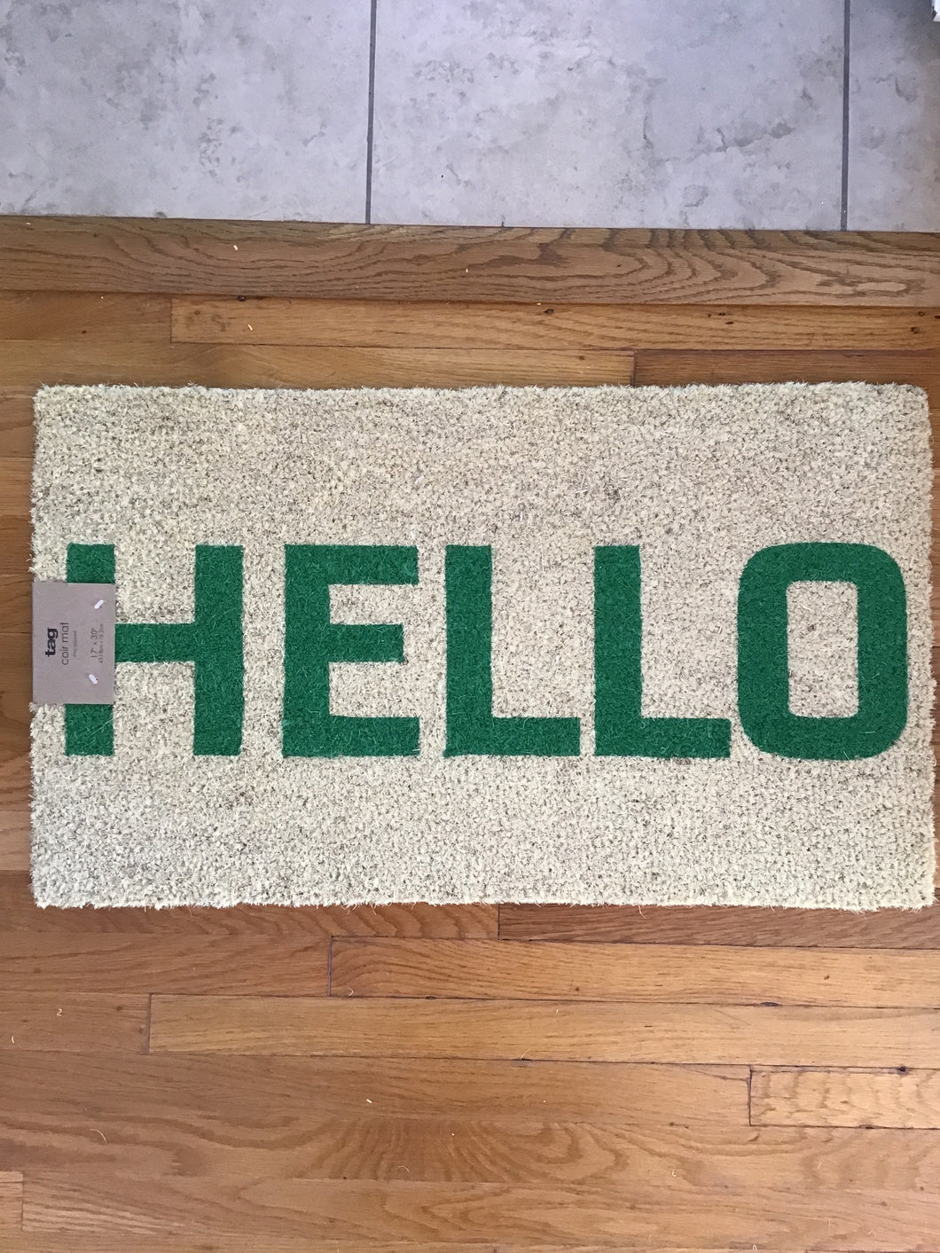 A rectangular white  doormat with the word 
