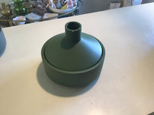 Load image into Gallery viewer, Black candle dish with lid. Lid has chip. Sitting on top of white countertop with a coffee table with knick knacks in the background.