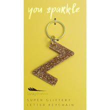 Load image into Gallery viewer, Gold glittery letter &quot;Z&quot; keychain on a yellow card with &quot;you sparkle&quot; in gold text, displayed against a white background. 