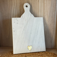 Load image into Gallery viewer, White marble serving board with handle and brass heart inlay.