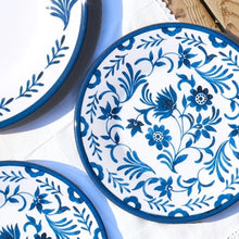 Load image into Gallery viewer, Blue and white melamine dinner plates with two different floral designs, displayed together on a white surface. 