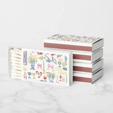 Load image into Gallery viewer, Set of matches with colorful pattern on a white background