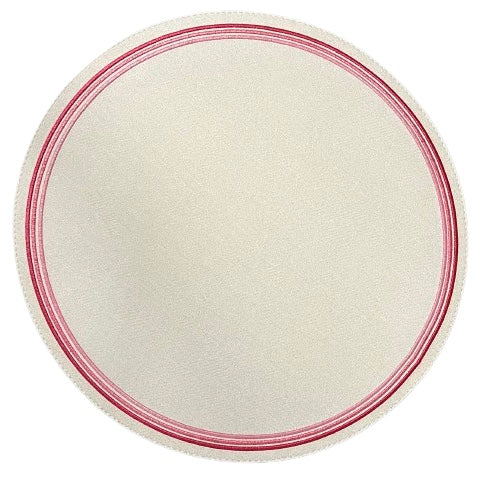 Round placemat with a pink embroidered border on a white background.