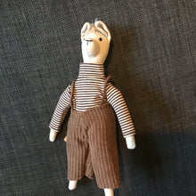 Load image into Gallery viewer, Toy figure wearing a striped shirt and brown overalls on a textured dark background
