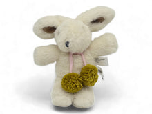 Load image into Gallery viewer, Vanilla cream-colored plush bunny toy with soft plush fabric, floppy ears with brown inner accents, and two large Australian merino wool chartreuse pom-poms hanging from a pink tie at its neck, displayed against a white background. 