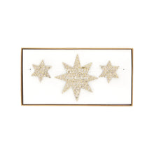 Load image into Gallery viewer, Glittery gold star garland with alternating large and small stars in clear packaging, displayed on a white background.  