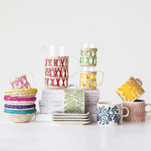 Load image into Gallery viewer, Collection of colorful ceramic tableware on a white background.