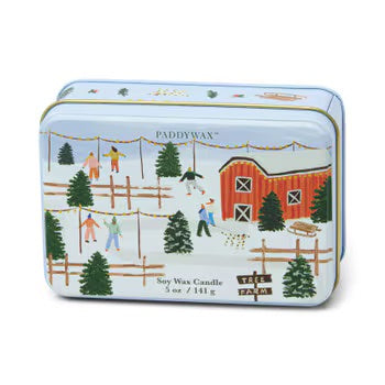 A rectangular shaped tin with lid against a white background. Tin sitting on its side, lid facing outward. Tin has a festive winter scene on the lid including a red barn, Christmas trees, and people playing in the snow. 