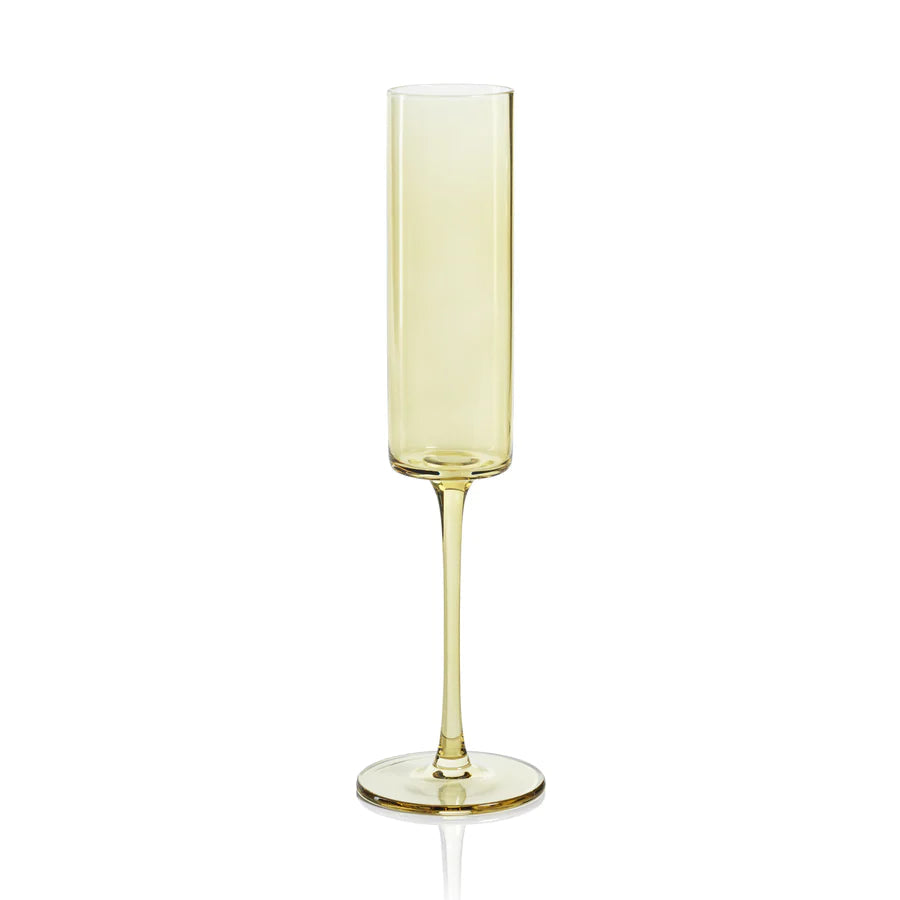 A single champagne flute with a light yellow hue on a white background.