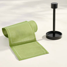 Load image into Gallery viewer, Matte black cocktail stand displayed beside a roll of green cocktail napkins on a white surface. 