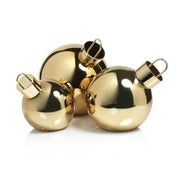 Three oversized gold metallic glass ornament balls in varying sizes with flat bottoms, metal rings at the top, and LED lights. Grouped together on a white surface. 