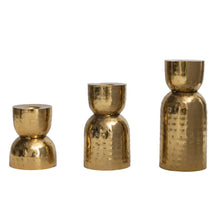 Load image into Gallery viewer, Three gold metallic candle holders of varying sizes on a white background