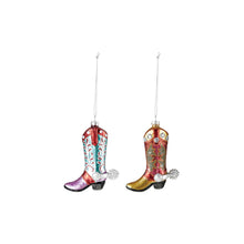 Load image into Gallery viewer, Hand-Painted Cowboy Boot Ornament, two glass cowboy boots featuring a purple toe with a light turquoise shaft and red-and-white detailing and a gold-colored toe with a red shaft and olive-green detailing, each with clear rhinestones, a silver-tone spur, and a gold hanging cord against a white background. 