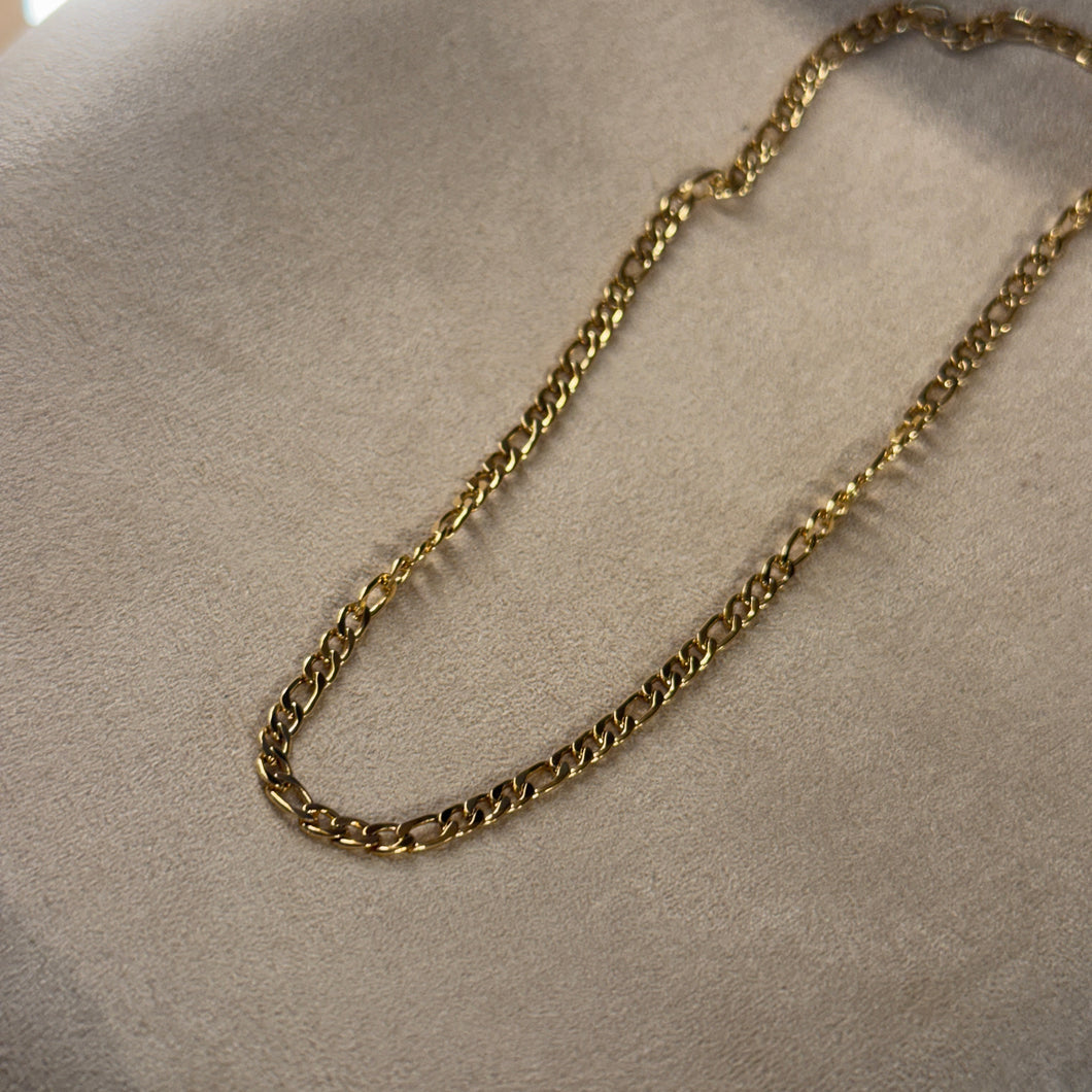 Gold chain on a neutral surface.