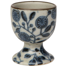 Load image into Gallery viewer, Danica Heirloom stoneware egg cup, featuring blue floral pattern on a cream background with brown rim, displayed on a white background. 