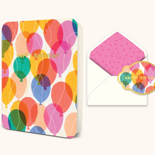 Standing ,opened greeting card with pink, red, blue, green, peach, yellow, and cream colored balloons and 