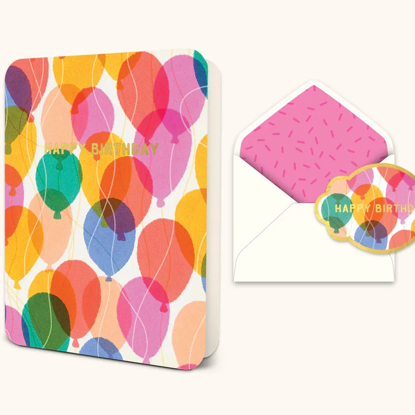 Standing ,opened greeting card with pink, red, blue, green, peach, yellow, and cream colored balloons and 