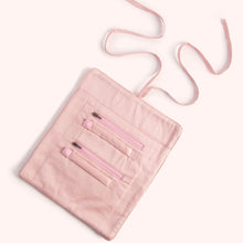 Load image into Gallery viewer, Open pink jewelry roll with two zippered compartments and two ring / accessory holders with a matching ribbon tie displayed flat on a white surface. 