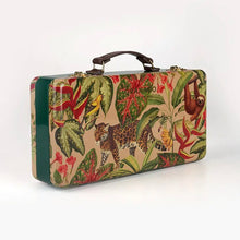 Load image into Gallery viewer, Granado Best-Sellers suitcase with tropical jungle illustration featuring a jaguar, sloth, birds, and lush foliage with green side panel and brown handle on a white background. 