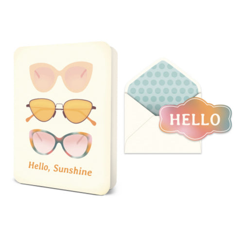 Slightly opened standing white greeting card with an illustration of 3 different sunglasses ,and 