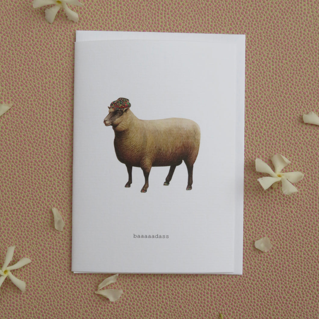 Greeting cards with a sheep illustration on a brown background with white flowers