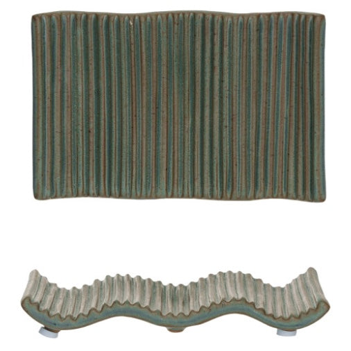 An overhead and side view of a dark green stoneware soap dish with small spaced vertical ridges on a white background.