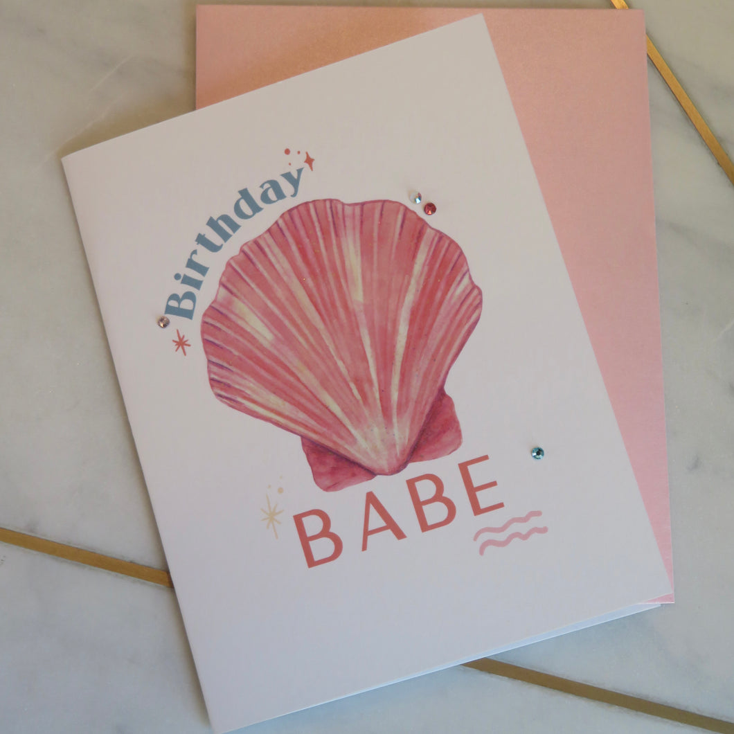 Greeting card with a pink shell and 