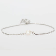 Load image into Gallery viewer, Freshwater pearl bolo bracelet featuring a single round pearl on a silver-plated adjustable chain, displayed against a white background. 