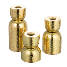Load image into Gallery viewer, Set of three gold candle holders on a white background