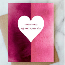Load image into Gallery viewer, Hand-painted pink and magenta greeting card with a centered white heart and "Mon Amour" script, shown with a kraft paper envelope. 