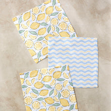 Load image into Gallery viewer, Geometry dishcloths with lemon pattern and blue wave pattern on separate towels, on a marble surface.