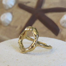Load image into Gallery viewer, Gold ring on a textured surface with starfish and shells in the background