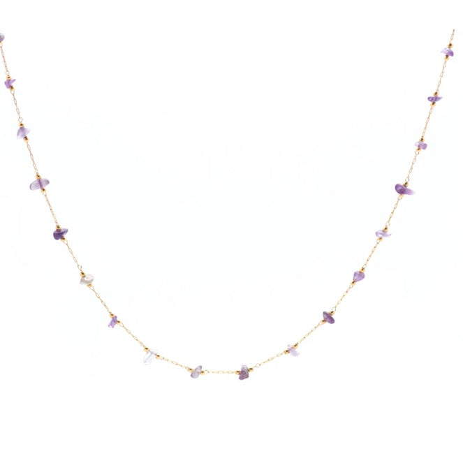Gold chain necklace with small purple  stones and gold accents on a white background