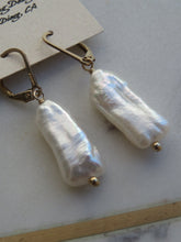 Load image into Gallery viewer, Pearl earrings with gold clasps on a light background