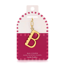 Load image into Gallery viewer, 14K gold-plated hand-painted enamel initial bag charm featuring the letter B with a scalloped edge design and a brushed gold finish, attached to a key ring and clasp. Displayed on a white and deep pink Lucky Feather card featuring pink dotted brush-stroke borders and labeled &quot;Bag Charm Hand Painted Enamel.&quot;  Displayed against a white background.