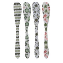 Load image into Gallery viewer, Holiday Spreaders | Four Styles, four white enameled stainless steel spreaders with different holiday designs- alternating sage green and olive green dot stripes, green ornaments with foliage, olive green poinsettias with leaves, and red candy canes and stars alongside green bells and ornaments- arranged vertically in a row against a white background.  