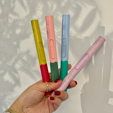 Load image into Gallery viewer, Four flameless rechargeable lighters in assorted colors, shown held in hand against a light background.