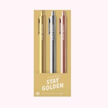 Load image into Gallery viewer, Pack of three &quot;Stay Golden&quot; Jotter gel pens in metallic gold, silver, and rose gold packaged in a beige sleeve with white text, displayed against a white background.  