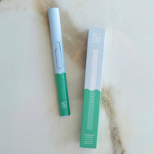 Load image into Gallery viewer, Light blue-and-green flameless rechargeable lighter next to its matching box on a marble surface.