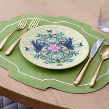 Load image into Gallery viewer, Decorative plate with floral design on a green placemat with cutlery on brown table top.