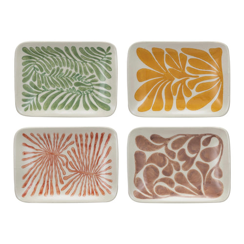 Four ceramic trays with leaf patterns in green, yellow, brown, and red on a white background.
