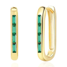 Load image into Gallery viewer, Gold-plated baguette earrings with slim rectangular emerald green stones displayed on a white background.