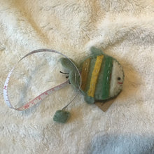 Load image into Gallery viewer, Felt fish measuring tape on a beige carpet.