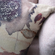 Load image into Gallery viewer, Abstract Printed Pillow,  square textured fabric pillow with dusty pink and plum watercolor pattern and subtle silver metallic details, shown in close-up on cream textured background.