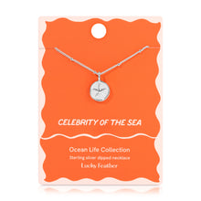 Load image into Gallery viewer, Sterling silver-dipped necklace featuring a small starfish charm pendant and a chain with delicate beaded accents, displayed on a peach-colored &quot;Celebrity Of The Sea&quot; Ocean Life Collection card by Lucky Feather with a white wavy border against a white background. 